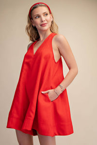 Red sleeveless V-neck flare romper with side pockets, perfect for Fourth of July, summer BBQs, and festivals