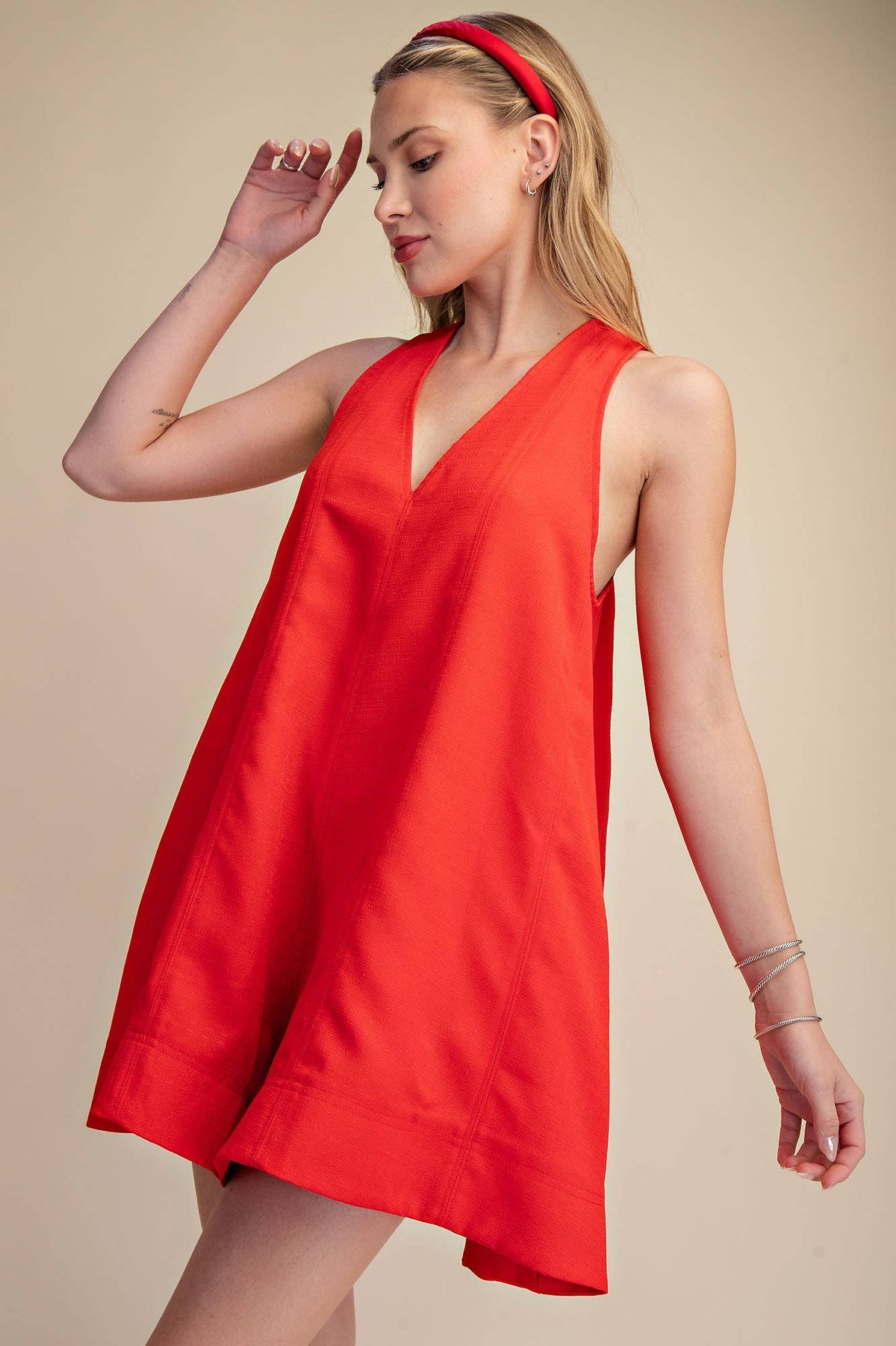 Red sleeveless V-neck flare romper with side pockets, perfect for Fourth of July, summer BBQs, and festivals