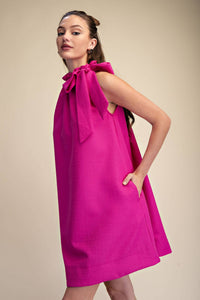 Magenta sleeveless mini dress with tie-front ruffle neckline and relaxed fit