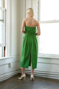 Textured woven green midi dress with strapless neckline, inverted pleats, straight skirt, back slit, and side zipper