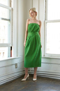 Textured woven green midi dress with strapless neckline, inverted pleats, straight skirt, back slit, and side zipper