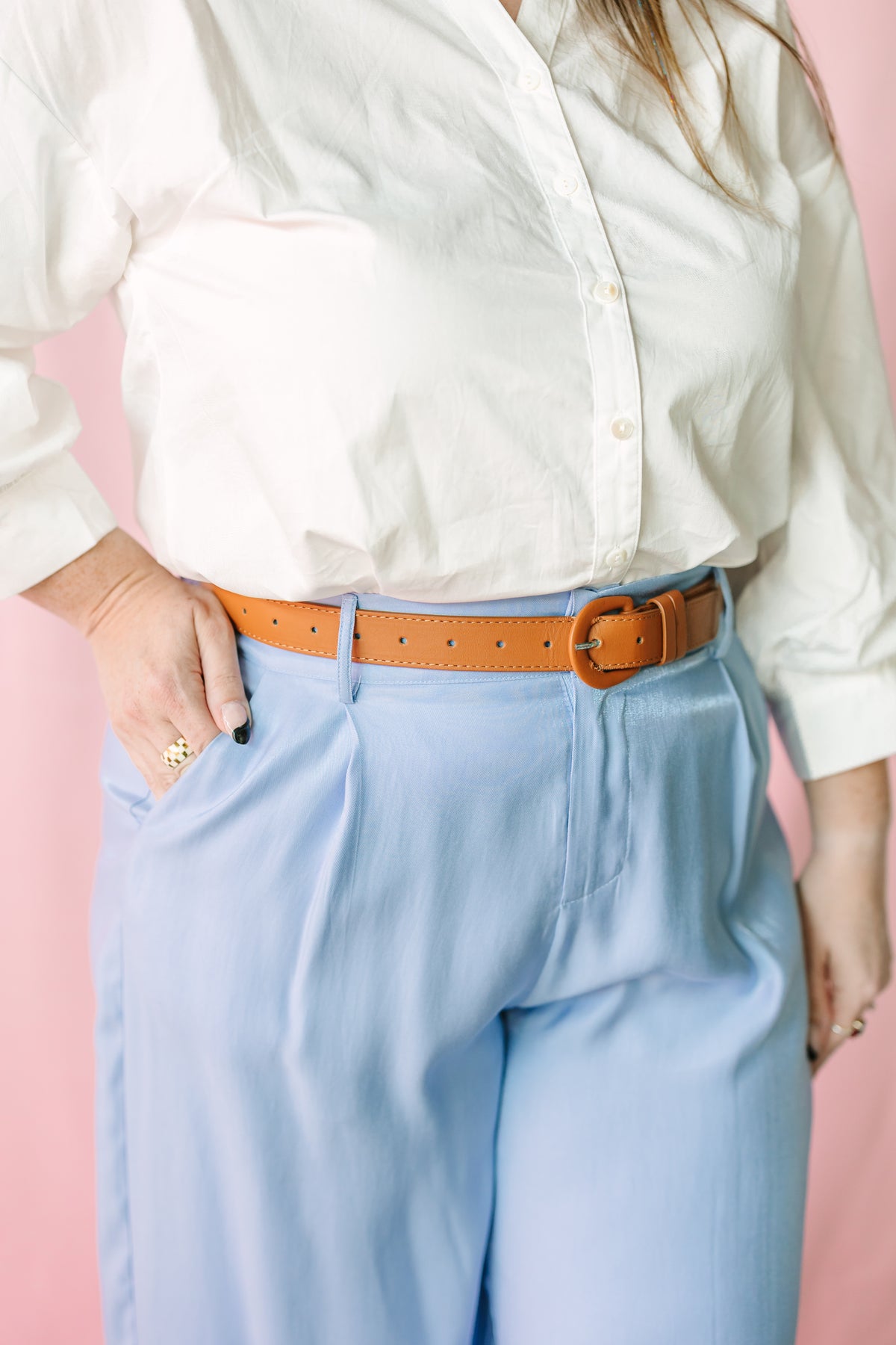 Close-up of High Waist Tailored Wide Leg Pants with structured waistband and tan leather belt 