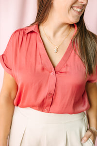 Berry Short Sleeve Blouse in coral by Naked Zebra — V-neck button-front detail with gathered collar and delicate gold necklace styling