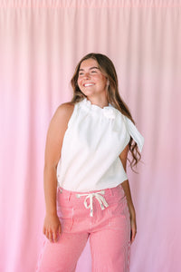 White Ruffle Neck Tie Blouse with ruffle neckline and neck tie, paired with red striped pants — three-quarter view