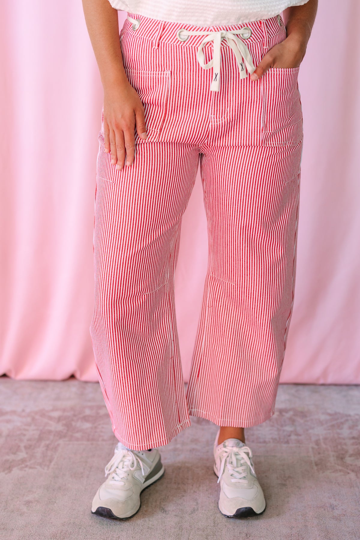 Pinstripe Barrel Pants in red and white stripes showing relaxed wide-leg silhouette and cropped length with white sneakers