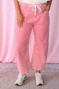 Pinstripe Barrel Pants in red and white stripes showing relaxed wide-leg silhouette and cropped length with white sneakers