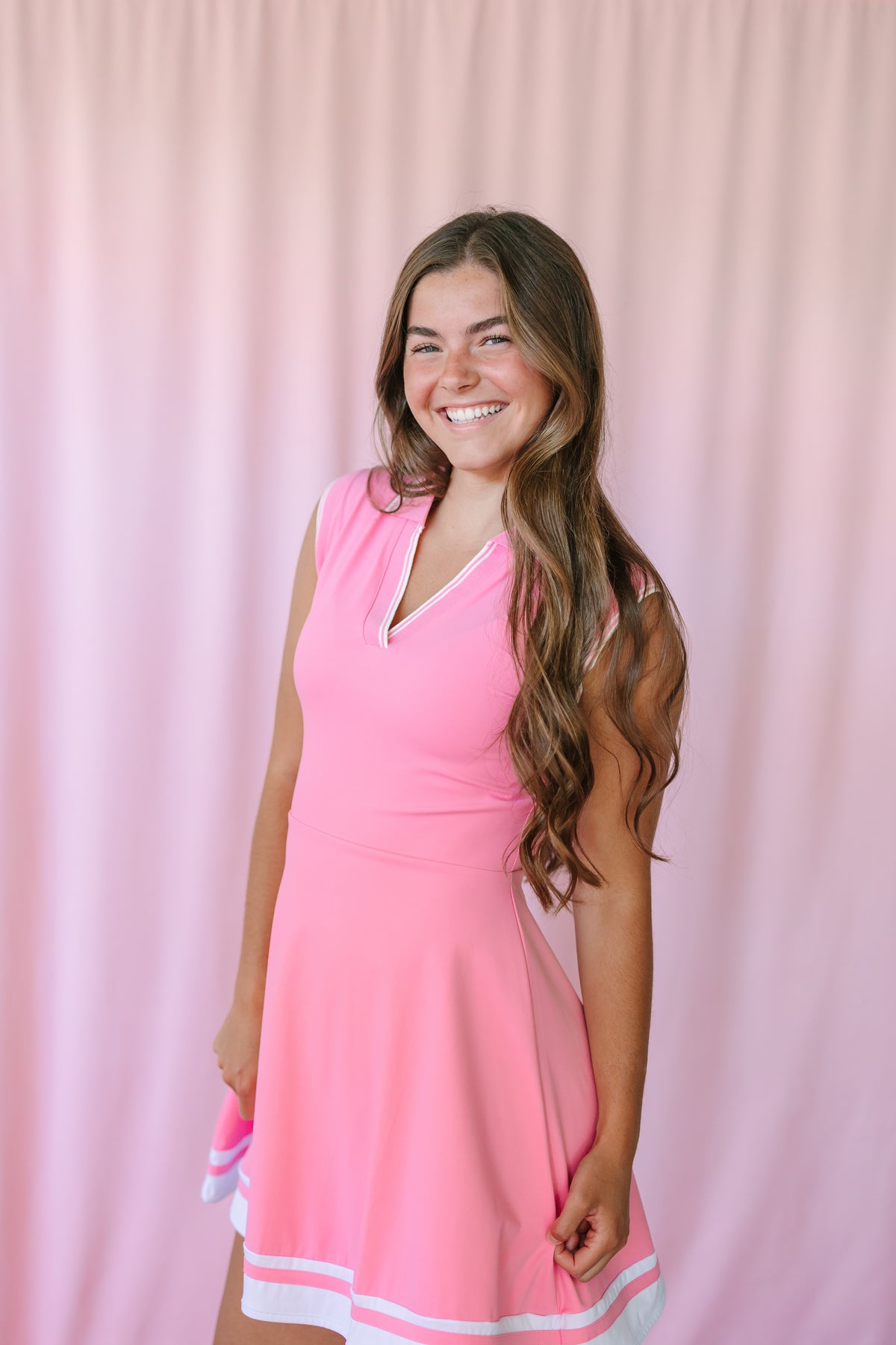 Pink Activewear Tennis Dress with white contrast trim at neckline and hem, sleeveless collared design