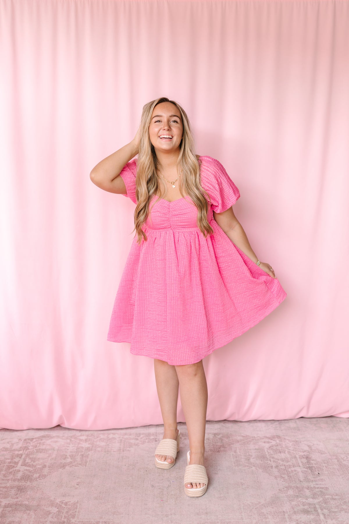 Pink textured woven babydoll dress with playful silhouette, perfect for spring and summer