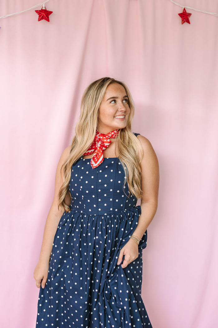 Navy polka dot midi dress side view showing midi length and relaxed fit