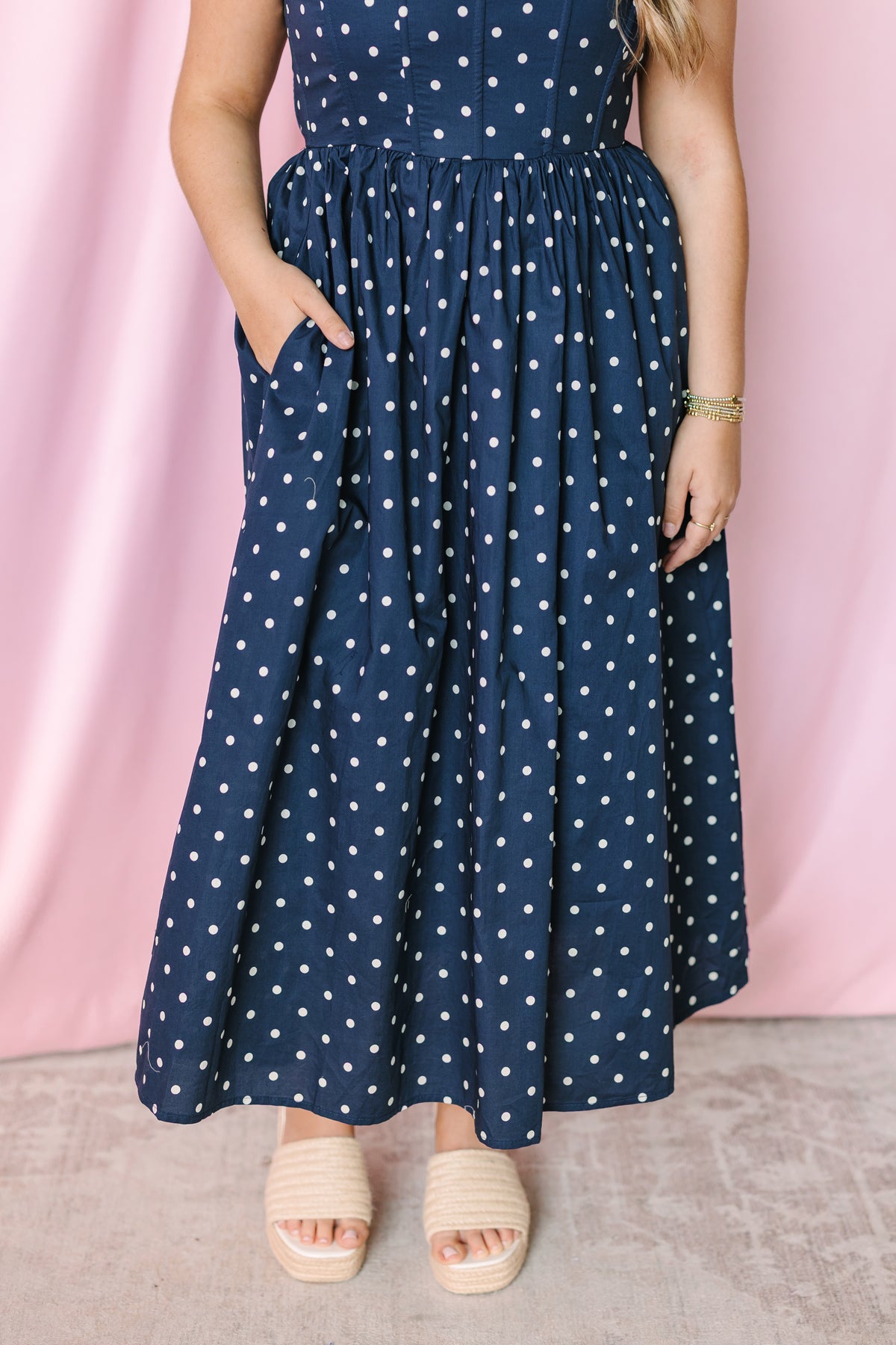 Navy polka dot midi dress detail view showing cotton fabric and pocket