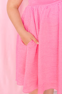 Pink textured woven babydoll dress with playful silhouette, perfect for spring and summer