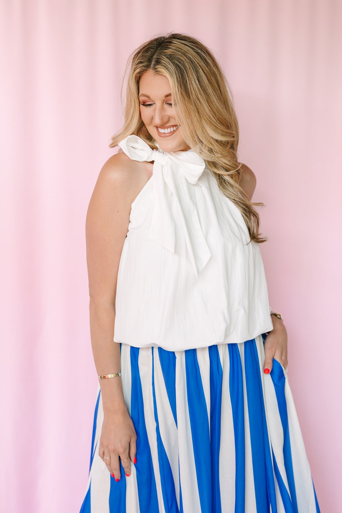 Close-up of tie-wrap detail on white sleeveless bubble hem top