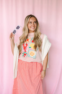 Women's pink nautical graphic tee, styled view with beach-inspired design