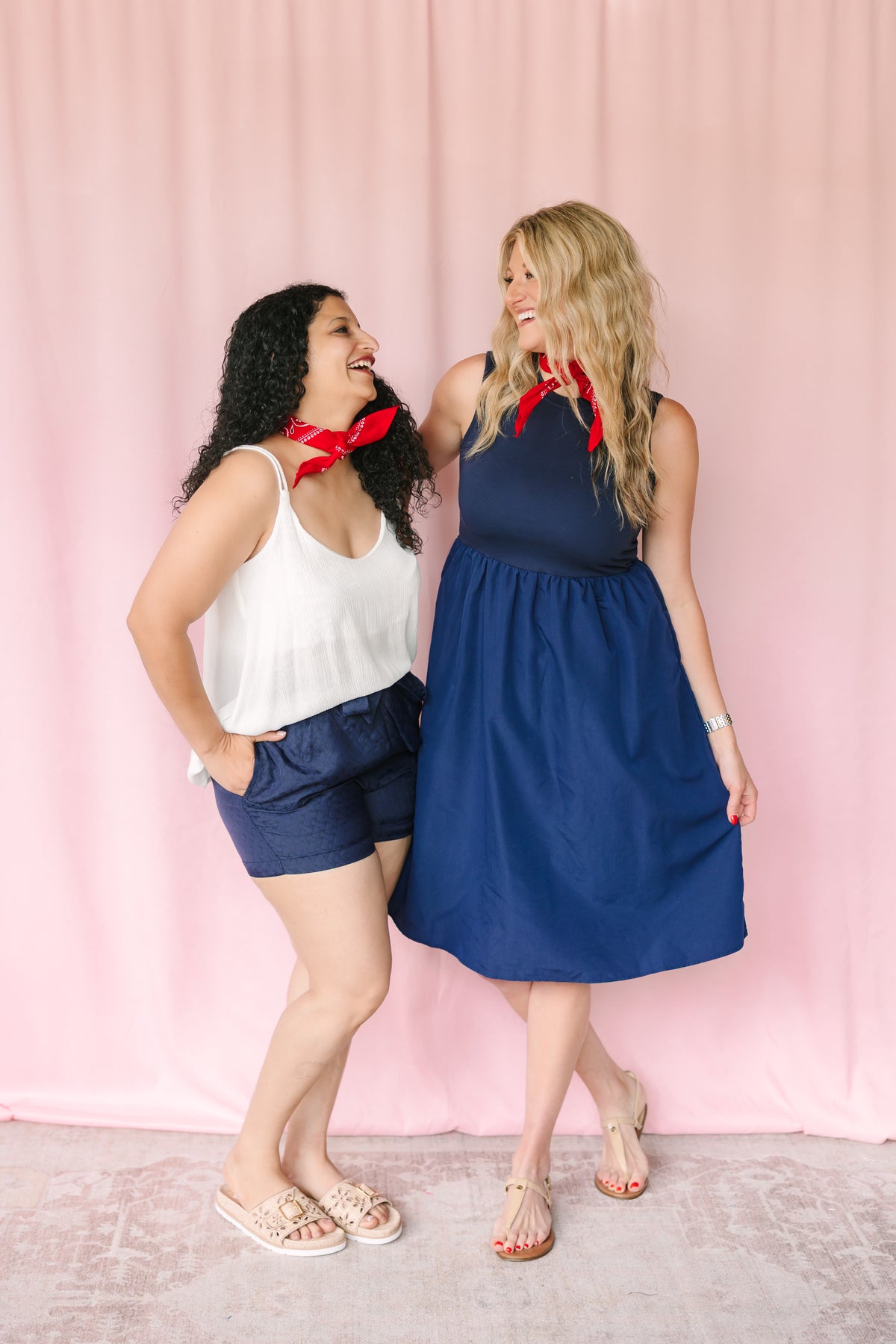 Model wearing a red cotton bandana tied at the neck with a blue casual outfit