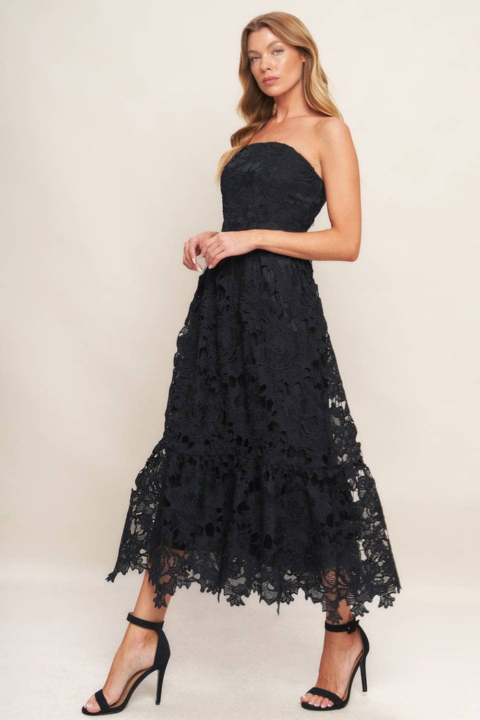 Black woven lace midi dress with straight neckline, ruffled hemline, and back zipper closure