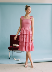 Fuchsia tiered ruffle midi dress with smocked bodice, adjustable tie straps, and lightweight cotton fabric