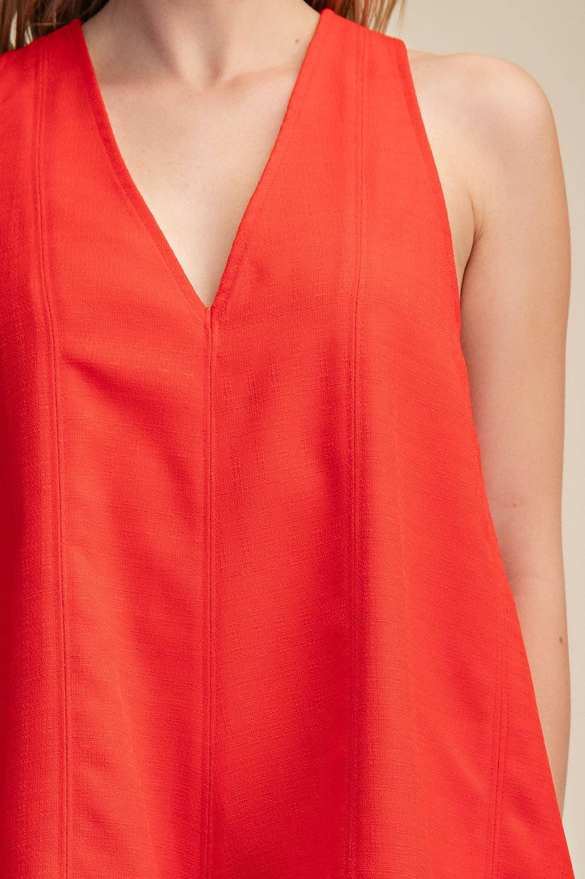 Red sleeveless V-neck flare romper with side pockets, perfect for Fourth of July, summer BBQs, and festivals