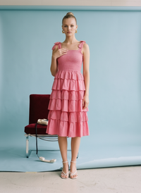 Fuchsia tiered ruffle midi dress with smocked bodice, adjustable tie straps, and lightweight cotton fabric