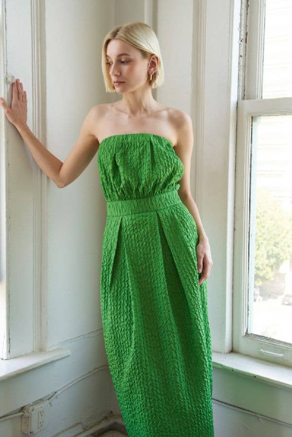 Textured woven green midi dress with strapless neckline, inverted pleats, straight skirt, back slit, and side zipper