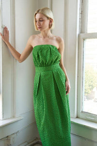 Textured woven green midi dress with strapless neckline, inverted pleats, straight skirt, back slit, and side zipper