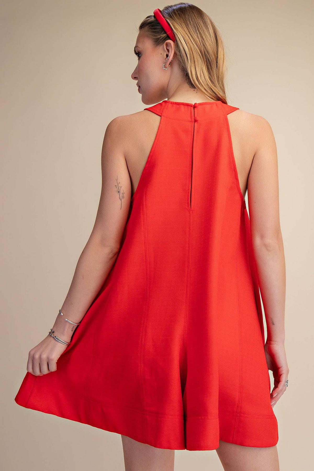 Red sleeveless V-neck flare romper with side pockets, perfect for Fourth of July, summer BBQs, and festivals